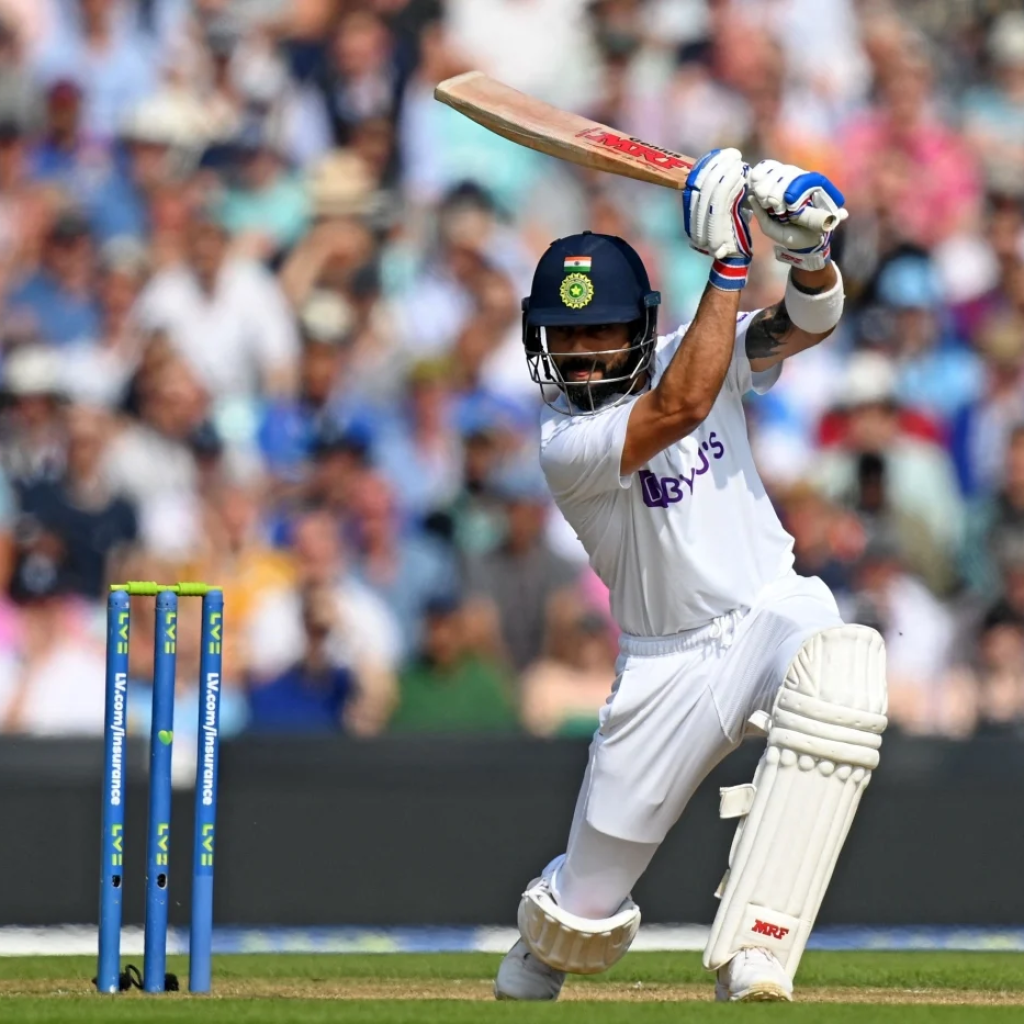 Batter in white cricket kit playing a shot during a match