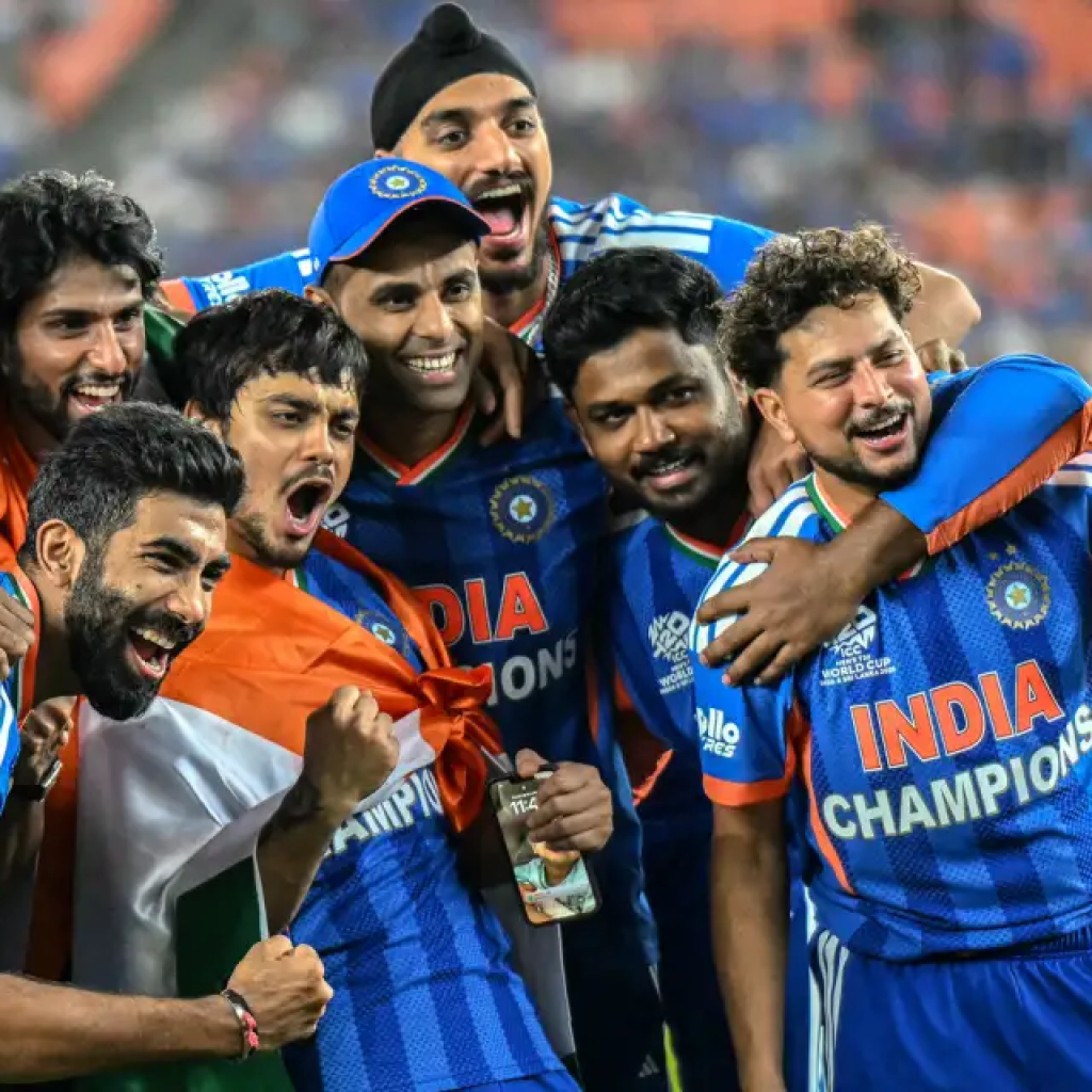 Indian cricket players celebrating together with the Indian flag.