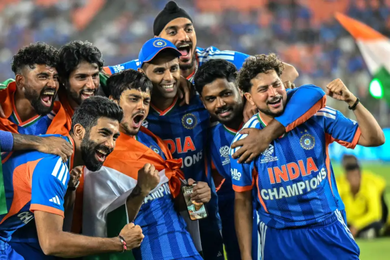 Indian cricket players celebrating together with the Indian flag.