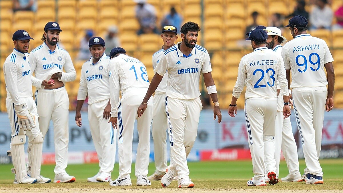 India cricket players gathered on the field wearing Test whites