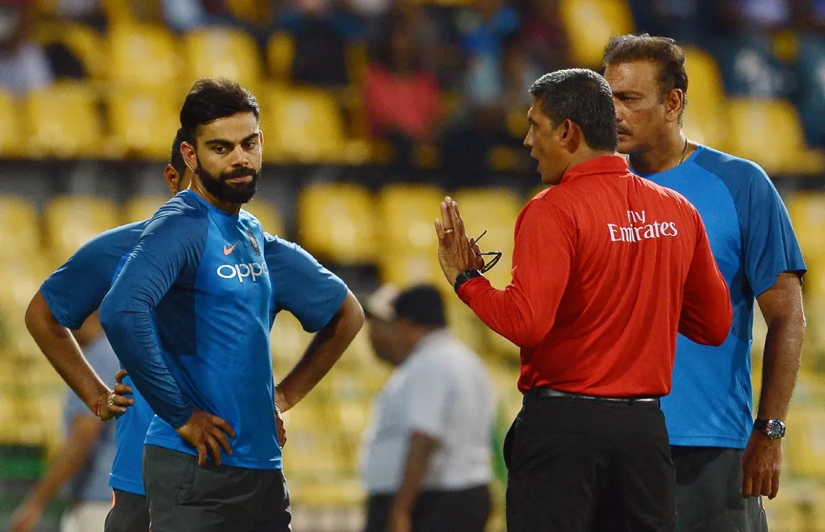 India team members speaking with an umpire on the cricket field