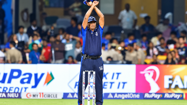Umpire giving the crossed-arm signal for an IPL Impact Player substitution